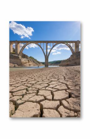 landscape of dry earth ground and viaduct, extreme drought in Entrepenas reservoir, in Guadalajara, Castilla, Spain Europe  