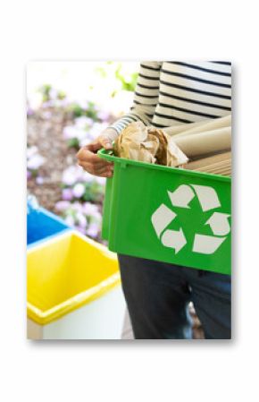 Close-up of a green basket with a recycling symbol with papers held by a woman