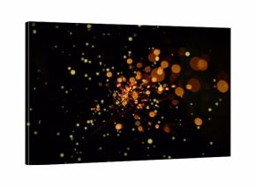 Flickering sparks glowing brightly in dark field, with ember-like light particles