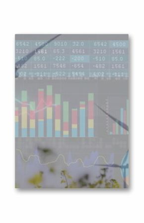 Displaying two wind turbines rising between tall grass at wind farm, with financial chart overlays