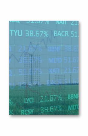 Showing wind turbines rotating over grassy plain toward mountain range, with stock ticker overlay