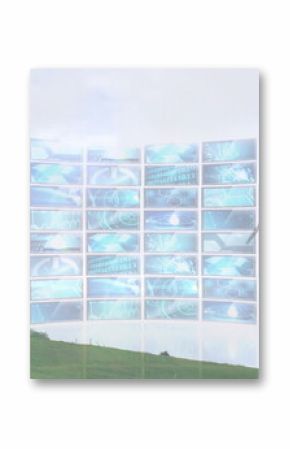Rotating wind turbine on grassy hill, with curved screen display showing digital data, copy space