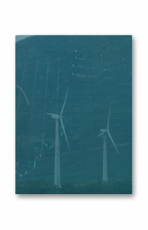 Four wind turbines spinning on grassy plain in mountain valley, with financial chart overlay