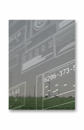 Displaying digital panels projecting readouts over green grass field, with wind turbines on horizon