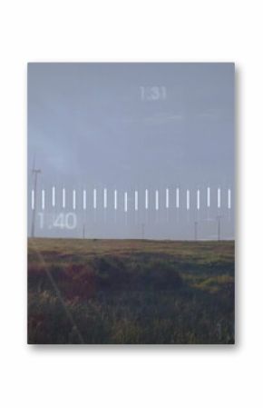 Displaying prominent wind turbine spinning on grass plain, with scale graphic overlay, copy space