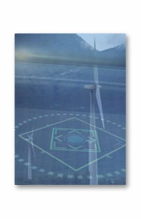 Displaying wind turbine rotating in foggy valley with holographic grid overlay and floating panels