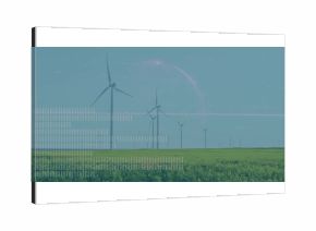 Spinning large wind turbine standing over agricultural field, with green crops and distant turbines