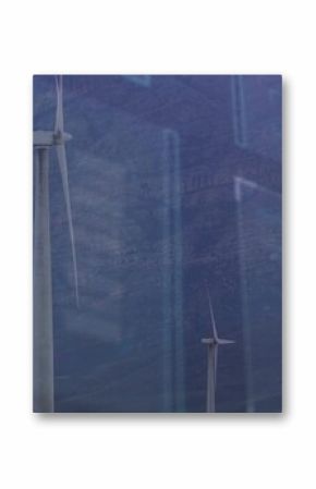 Towering large wind turbine capturing data analytics over mountain valley, with blue data overlays