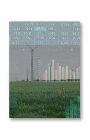 Displaying wind turbine standing on grass field with mountain ridge, chart overlays, data tables