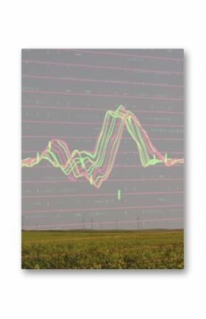 Showing row of wind turbines rising over green crop field at wind farm, with digital grid