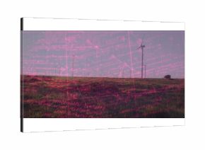 Standing tall white wind turbines rotating on grassy hill wind farm with distant trees