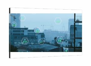 Floating hexagonal icons showing green energy ideas above railing in urban skyline with cranes