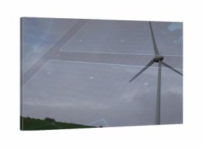 Standing wind turbine rotating on grassy hill under overcast sky, with grid overlay, copy space