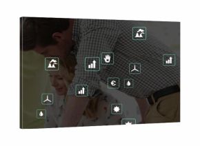 Leaning team of four in checked shirt, blouse reviewing data at meeting table, with laptop overlay