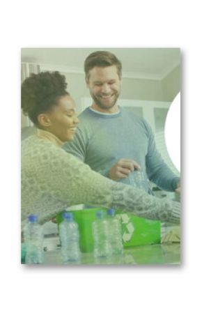 Image of go green text and light spots over diverse couple sorting plastic bottles