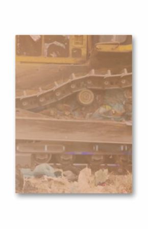 Image of glowing light over bulldozer in waste disposal site