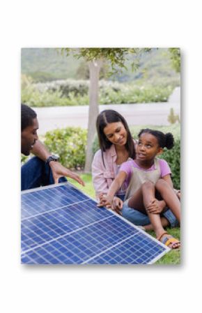 Family exploring solar panel technology together in sunny backyard garden