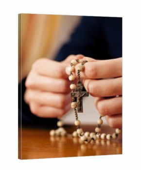 Woman praying with rosary to God