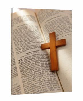 wooden cross on a old bible