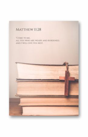 Matthew 11:28 Vintage tone of wooden cross on book background