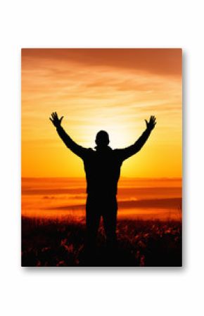 Silhouette of a man praying while facing the sun during Autumn
