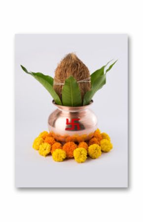 copper kalash with coconut and mango leaf with floral decoration. essential in hindu puja, front view, closeup
