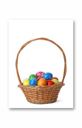Decorated Easter eggs in wicker basket on white background