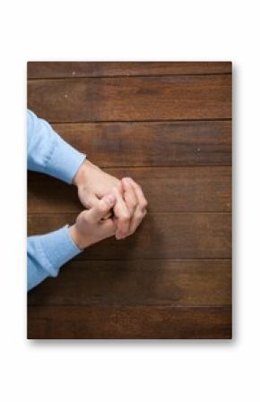 Man praying on wooden table