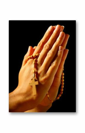 Christian human praying with rosary in hands