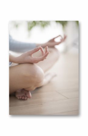 Woman meditating in the lotus position closeup