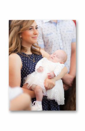 Happy mother with baby on christening ceremony in church