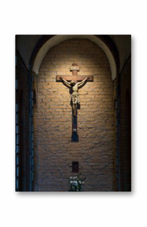Dark artistic old cross on a shaded rough textured brick wall
