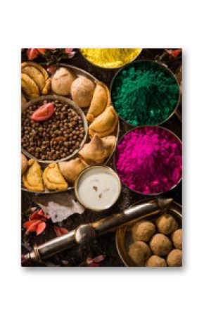 holi festival food with colours, indian festival holi, samosa, kachori, laddu, gujiya, palash flower, thandai, farsan, chana masala, puran poli or roti, indian festival of colours called holi