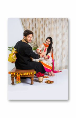 Indian young sister tying rakhi on brother's wrist, a tradition on Raksha Bandhan festival