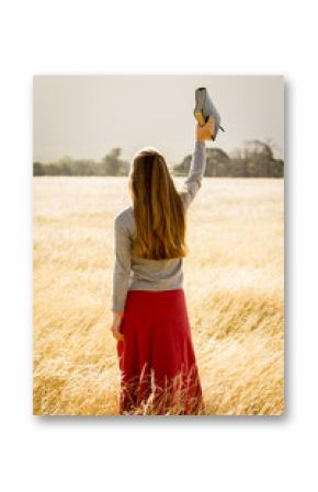 Girl Holding Bible in Air