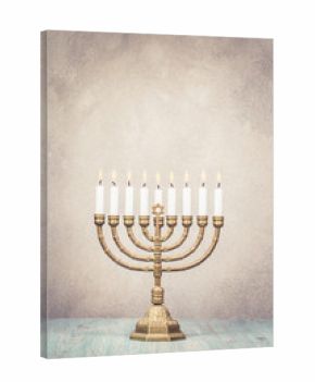 Bronze Hanukkah menorah with burning candles on wooden table front old vintage concrete wall background. Holiday greeting card concept. Retro style filtered photo