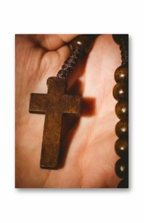Hand holding rosary beads