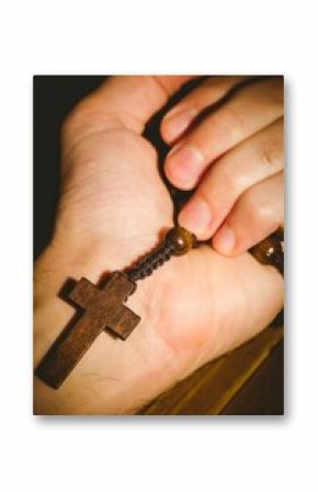 Hand holding rosary beads