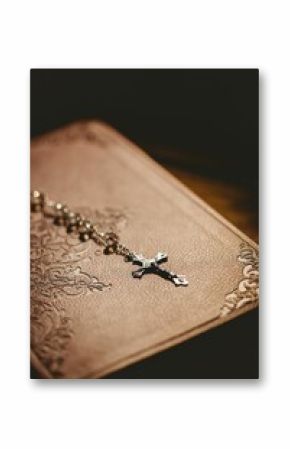 Close-up of rosary beads on bible