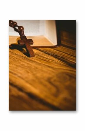 Bible and rosary beads with wooden cross