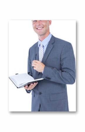 Portrait of smiling businessman with diary and pen