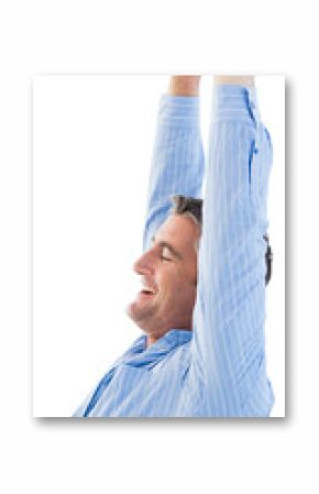 Relaxed businessman stretching with arms raised