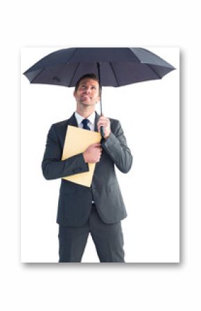 Businessman sheltering under umbrella holding file