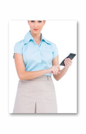 Serious classy businesswoman using calculator