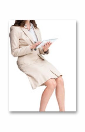 Businesswoman holding tablet and looking up