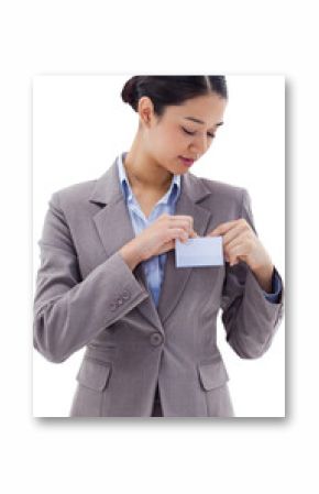 Portrait of a businesswoman clipping her badge
