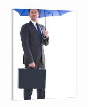 Serious businessman holding his umbrella and briefcase