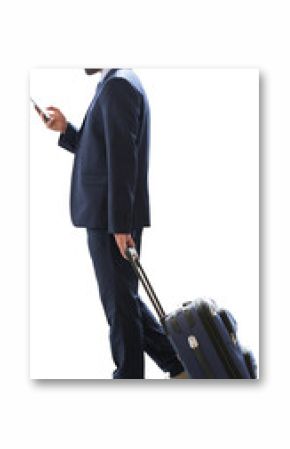 Full length of businessman with luggage using phone
