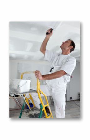 craftsman painting the ceiling
