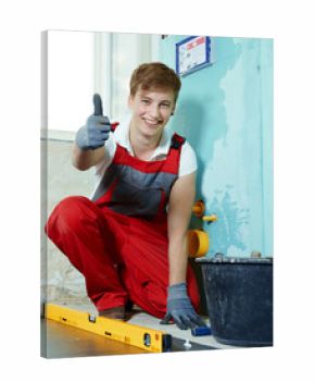 Apprentice for sanitary installations at work shows thumb up